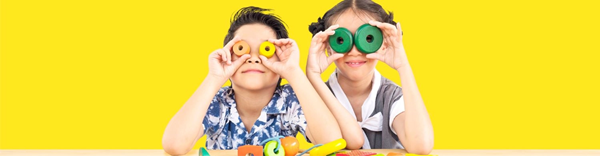 Happy children interacting with toys in a vibrant environment.
