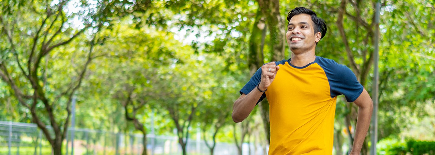 Person jogging outdoors, encouraging heart health